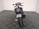 a motorcycle that is parked in a room with a checkered floor