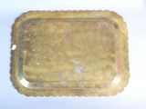 a gold tray on a white table with a white background