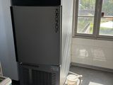 a refrigerator and a freezer in a room with windows