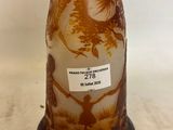 a brown vase with a design on it on a table
