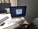 a desk with a computer monitor and a keyboard on it