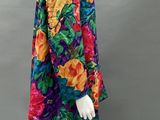 an image of a mannequin wearing a colorful dress with flowers on it