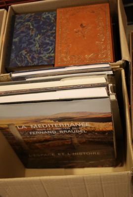 boxes of books are stacked on top of each other in a room