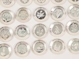a lot of different types of silver coins on the table