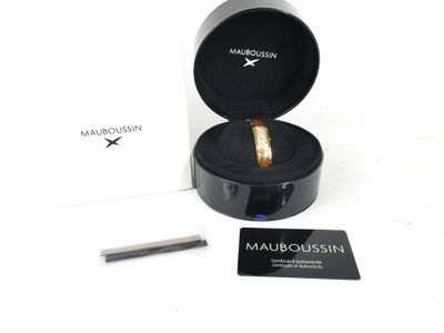 a box with a ring inside of it on a white surface