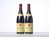 two bottles of red wine sitting on top of a table