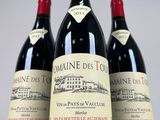 three bottles of wine sitting on top of a table next to each other