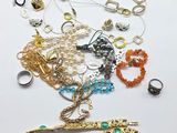 many different types of jewelry on a white surface