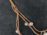 a close up of a necklace on a mannequin mannequin