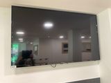 a flat screen tv hanging on the wall in the room