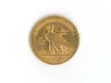 a gold coin with a bird on it on a white surface