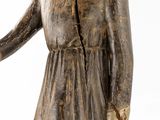 wooden statue of a man holding a baseball bat in his right hand