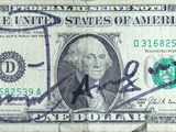 an old one dollar bill with a stamp on it ' s side