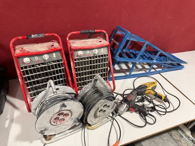 two air compressors sitting on a table next to a pile of wires