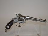 gun on display on clear acrylic stand with white background