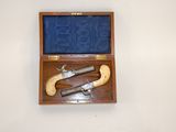 a wooden case with two guns inside of it
