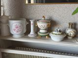 de nombreux vases posés sur une étagère, avec un miroir en arrière-plan