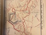 an open book with a map of a city and a red line on it