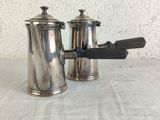 pair of antique silverplated coffee pots with a wooden handle