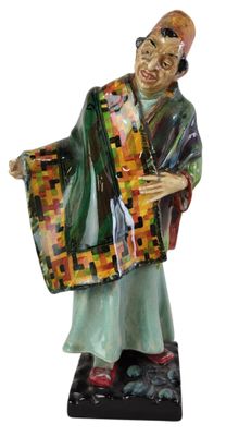 figurine of a man holding a bag and wearing a robe