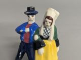 a figurine of a man and a woman standing next to each other