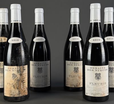 six bottles of wine are lined up in a row on a table