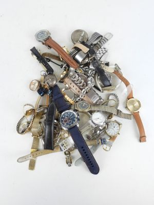 a pile of assorted watches and watches on a white surface