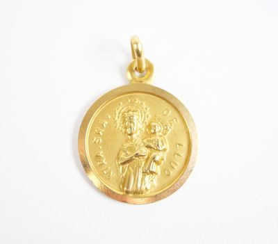a close up of a gold medal on a white surface