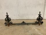 an antique cast iron fireplace grate with ornate design