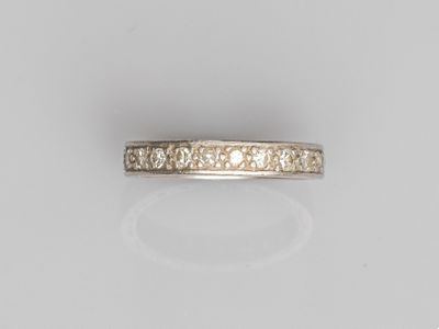 a white gold ring with diamonds on a white background