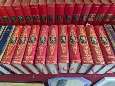 a lot of books that are sitting on a shelf