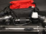 a camera and a camera bag on top of a tripod