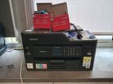a printer sitting on top of a counter next to a window
