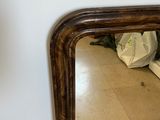 a mirror that is sitting on the floor next to a wall