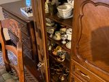 a wooden cabinet with a glass door in a room
