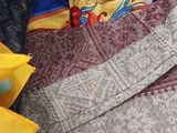 a box full of clothes and other items on a bed