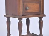 a small wooden table with a drawer on top of it