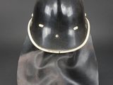 a black helmet with a gold ring on top of it