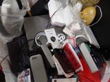 a pile of electronic devices and other electronics on a table