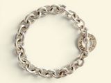 a close up of a silver bracelet with a lock on it