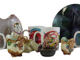 a lot of coffee mugs and a plate on the table