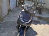 a scooter parked in front of a garage door