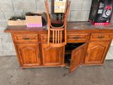 a wooden desk with a chair on top of it