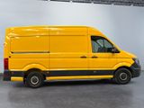 the yellow van is parked in the garage with the door open