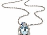 a close up of a necklace with a blue topaz and white topaz stones