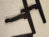 two pieces of black plastic sit on top of a white sheet