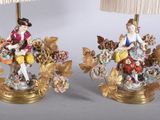 pair of antique lamps with figurines of women and flowers on them