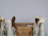three figurines that are sitting next to a box