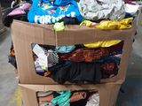a cardboard box filled with clothes in a warehouse