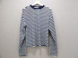 a white and blue striped shirt hanging on a hanger